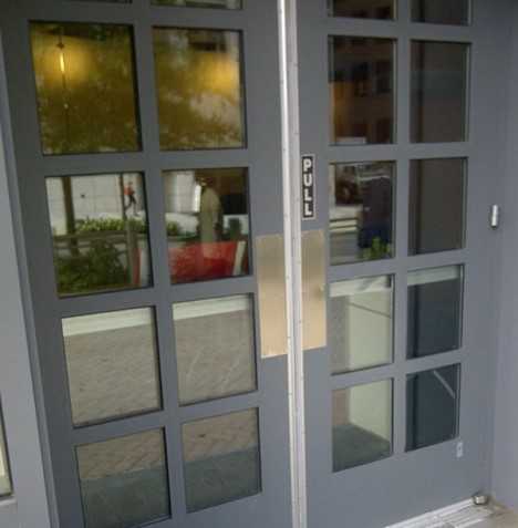 Push doors, no handles, with a pull sign.